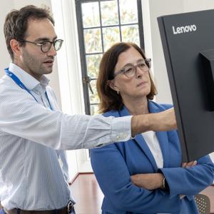 Two researchers look at a computer monitor