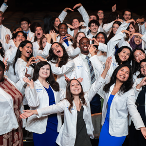 First year MD students strike funny poses after receiving their white coats. 